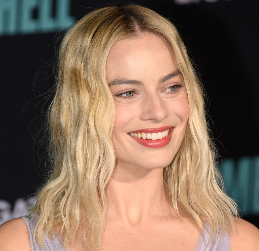 actress Margot Robbie with blonde hair and blue eyes