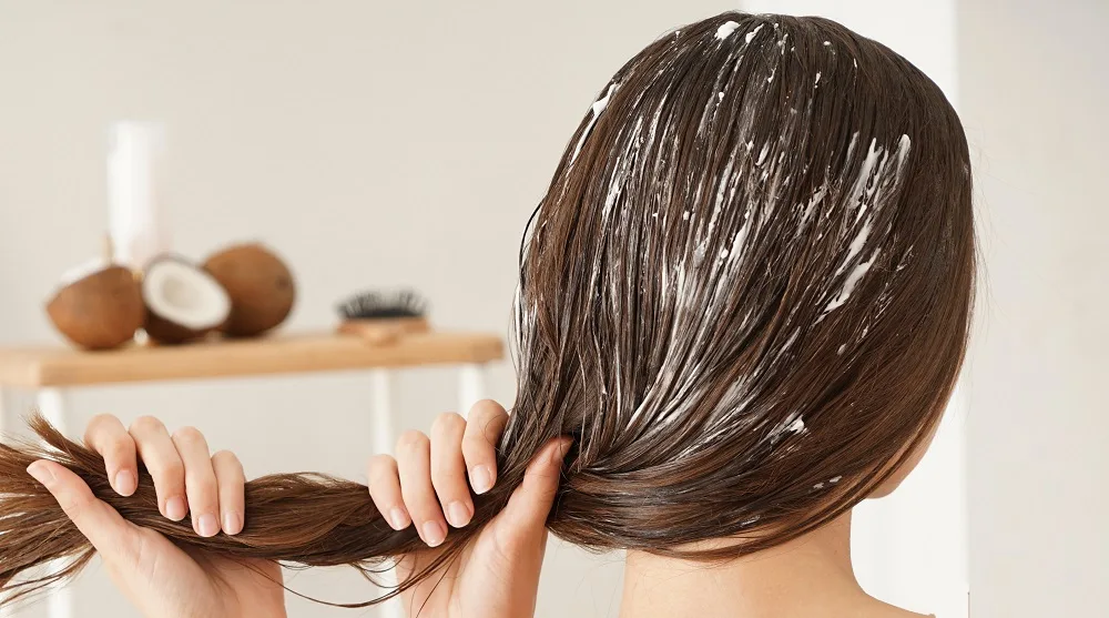 applying coconut oil on hair