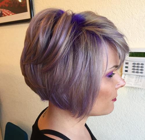 Stacked ash blonde bob haircut with vibrant purple highlights and textured layers.