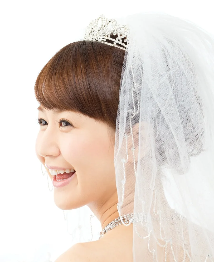 asian wedding hairstyle with tiara and veil