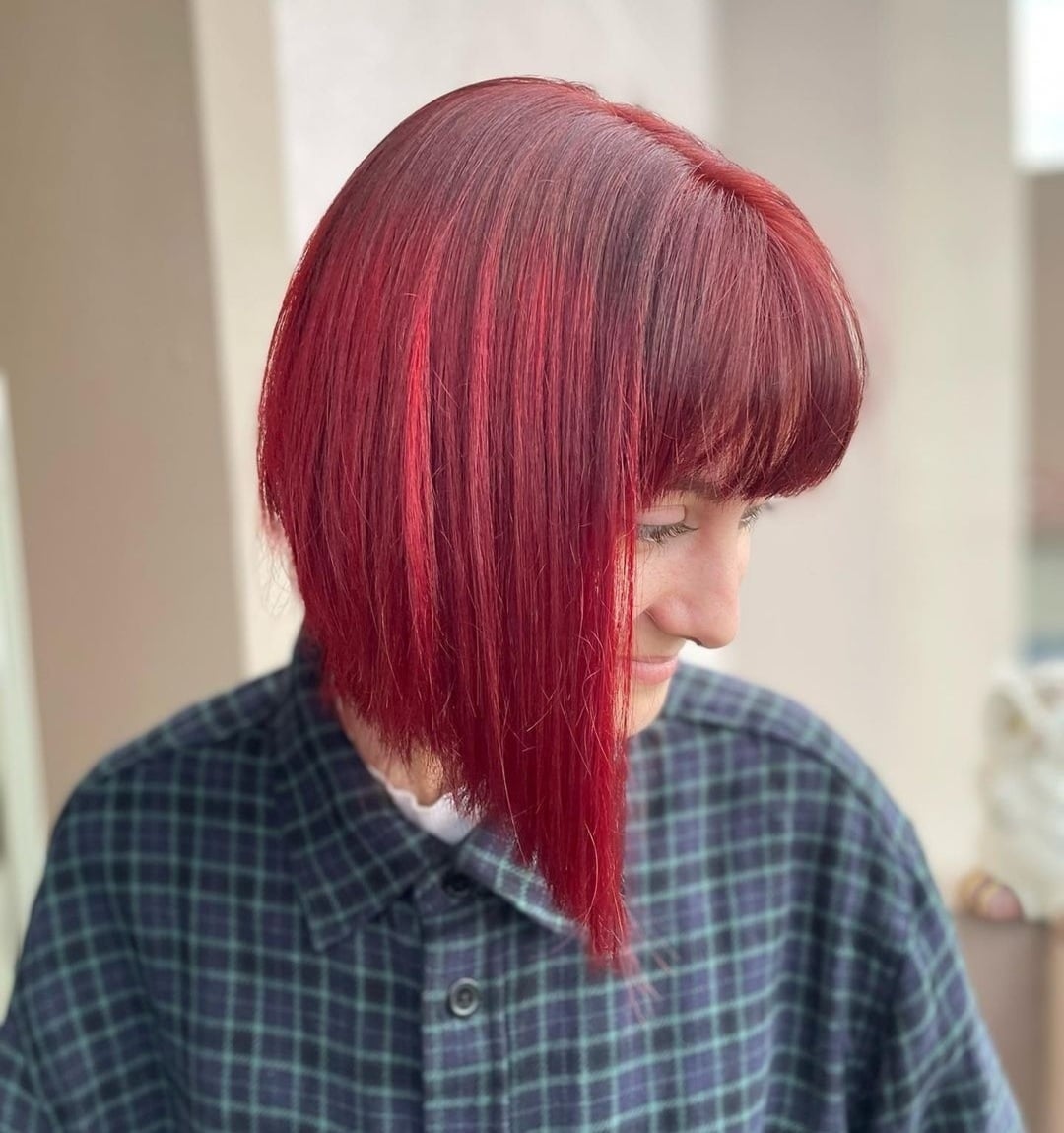 Asymmetrical straight red wine bob haircut with blunt bangs