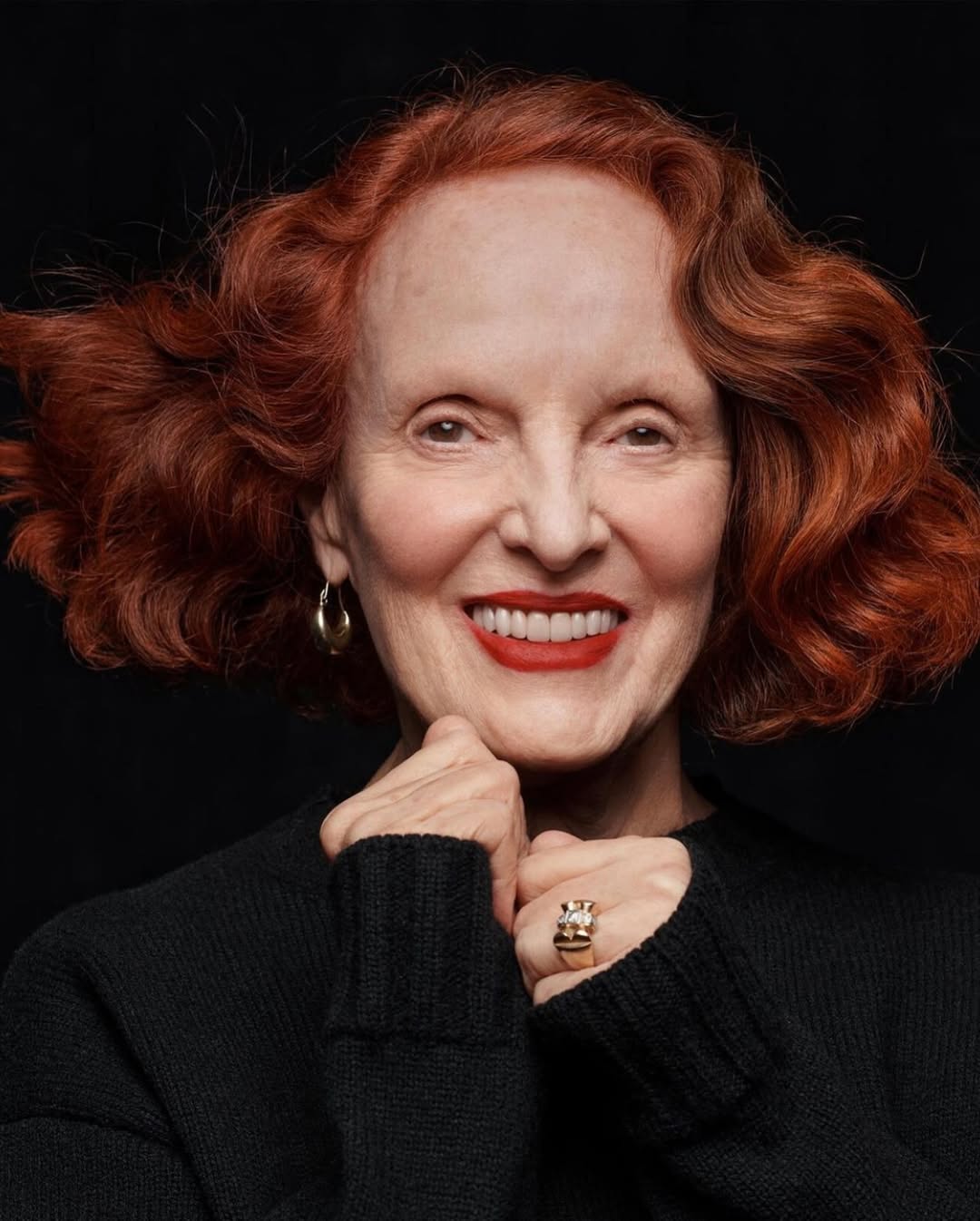 older woman with wavy auburn hair