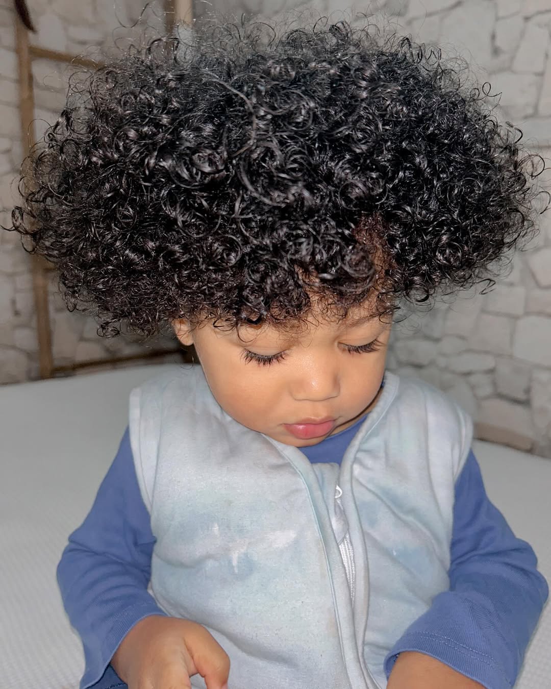 baby full voluminous curly afro showing off natural dark ringlets