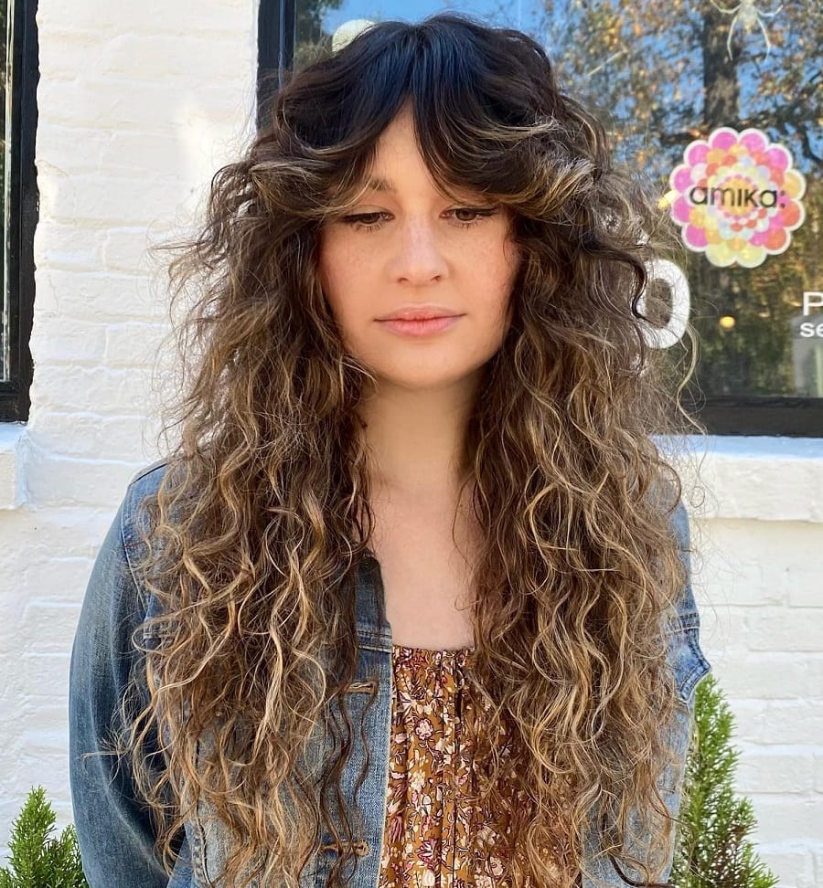 balayage curly hair with curtain bangs