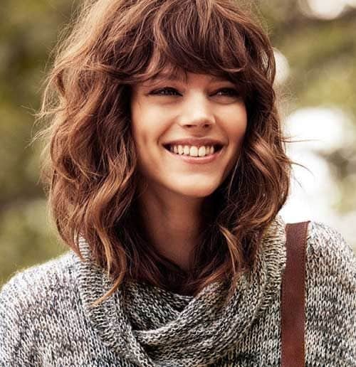 medium length wavy haircuts with bangs