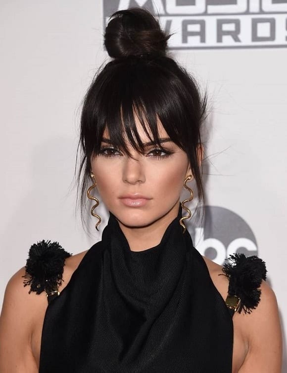 messy top knot with bangs