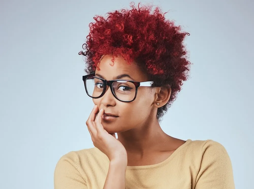 black girl's red curls with glasses