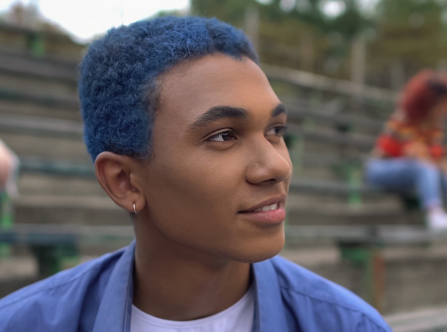 black guy with curly blue hair and round face