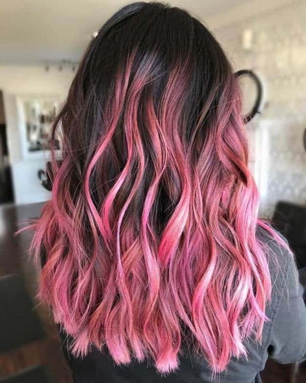 black wavy hair with pink highlights