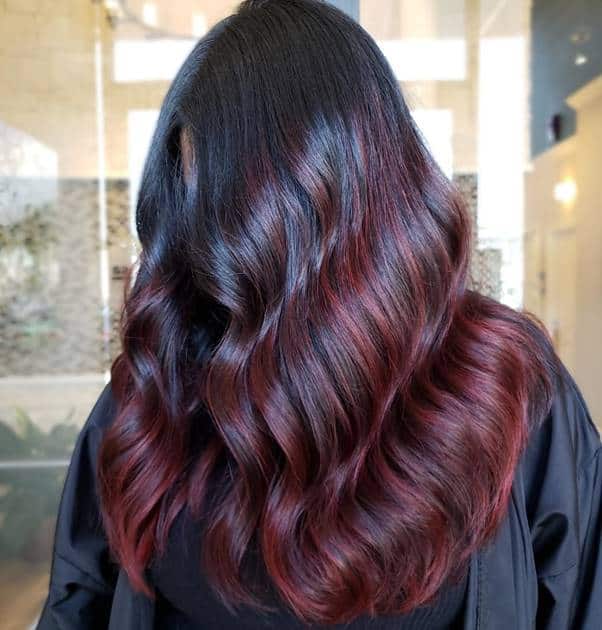 wavy black hair with dark red highlights