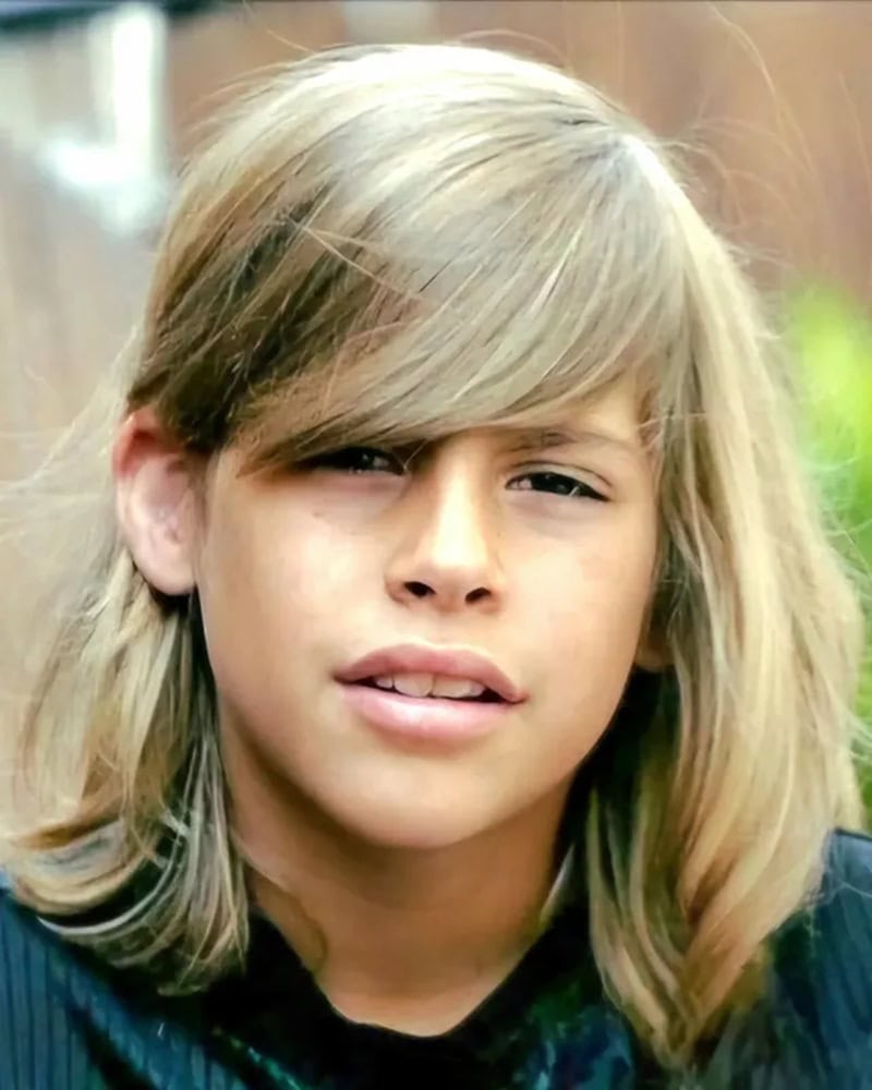 Blonde boy with side-swept long layered haircut