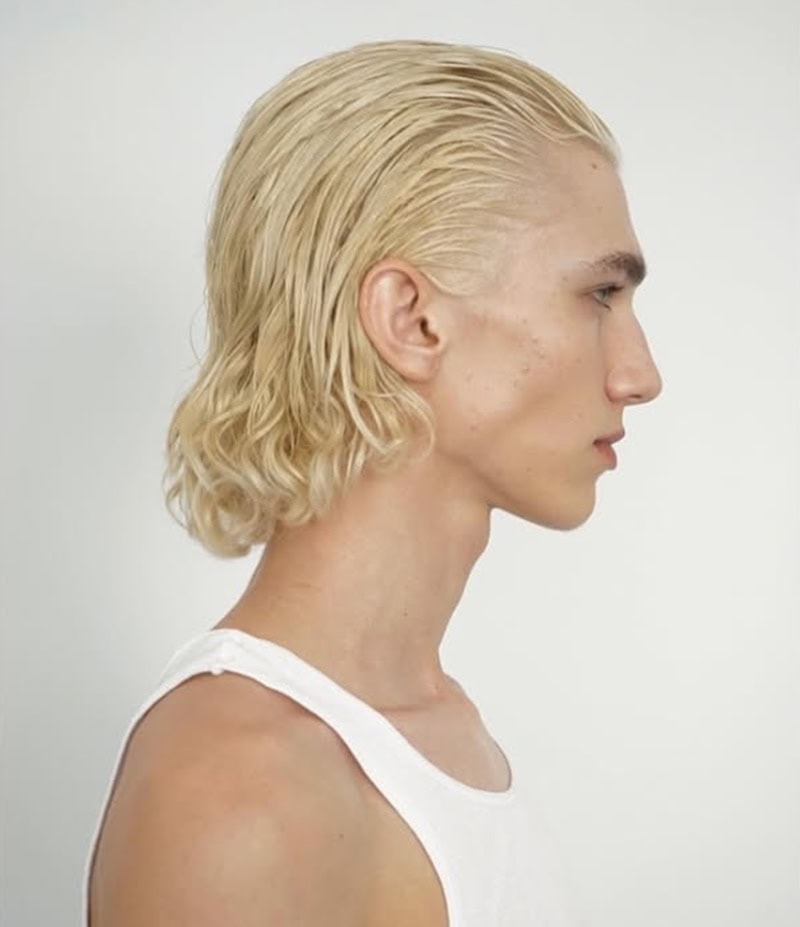 blonde boy with wet-look long hair slicked back