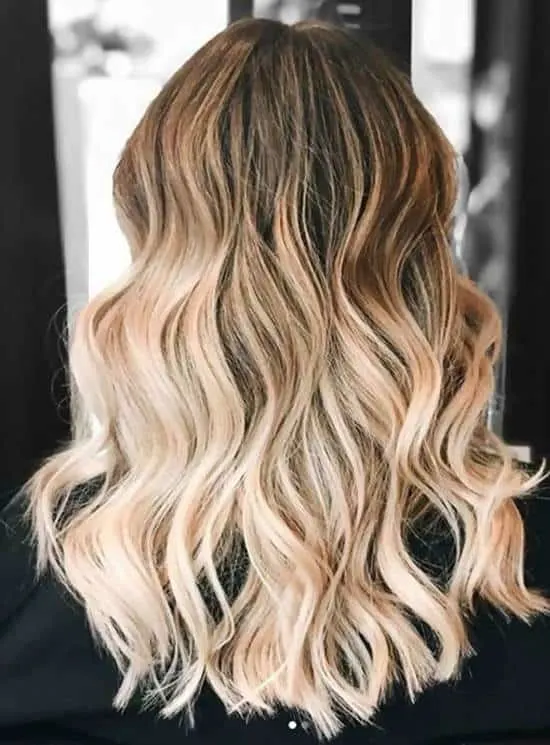 wavy blonde hair with dark roots