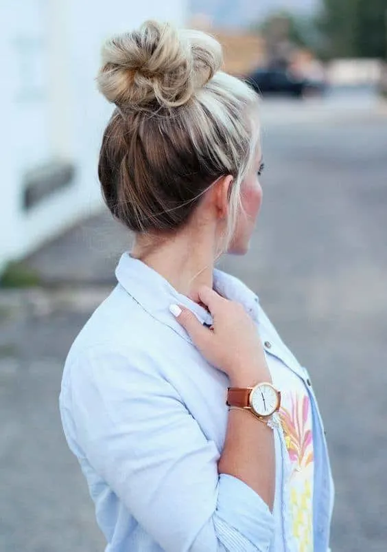 blonde messy bun with brown underneath