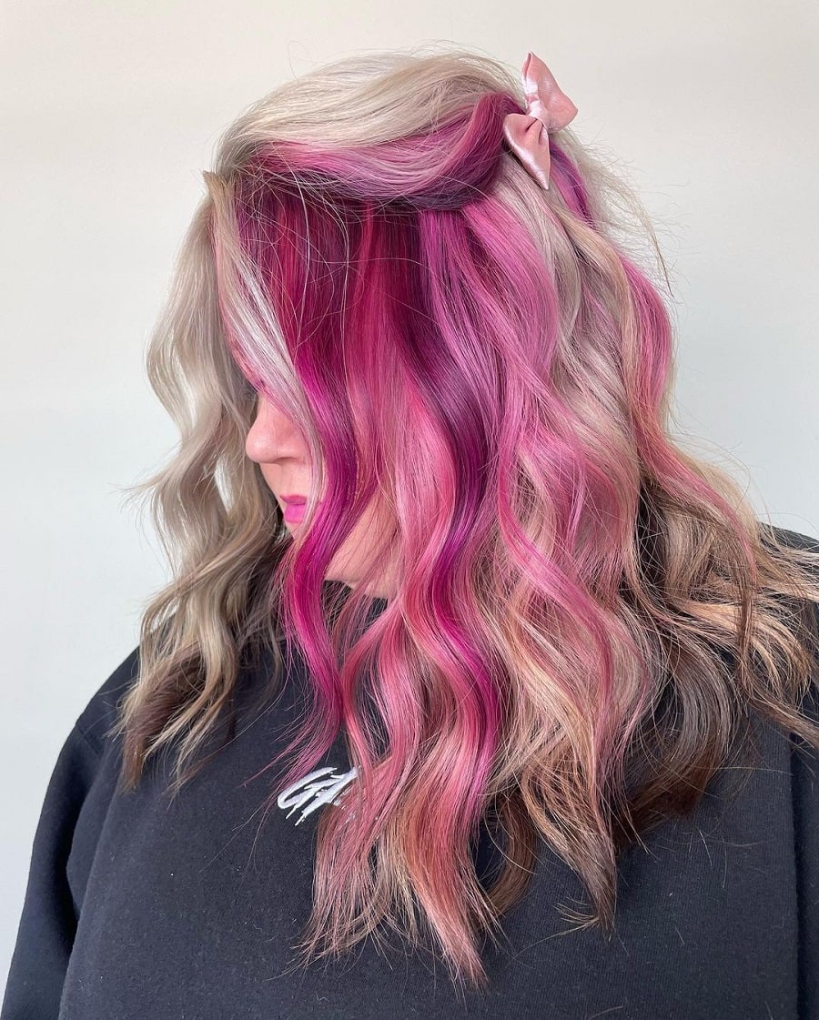 Blonde hair with pink highlights underneath