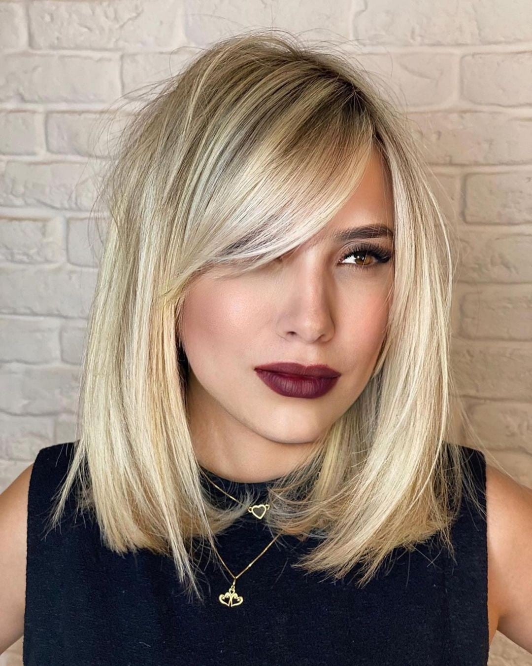 blonde lob haircut and long sideswept bangs