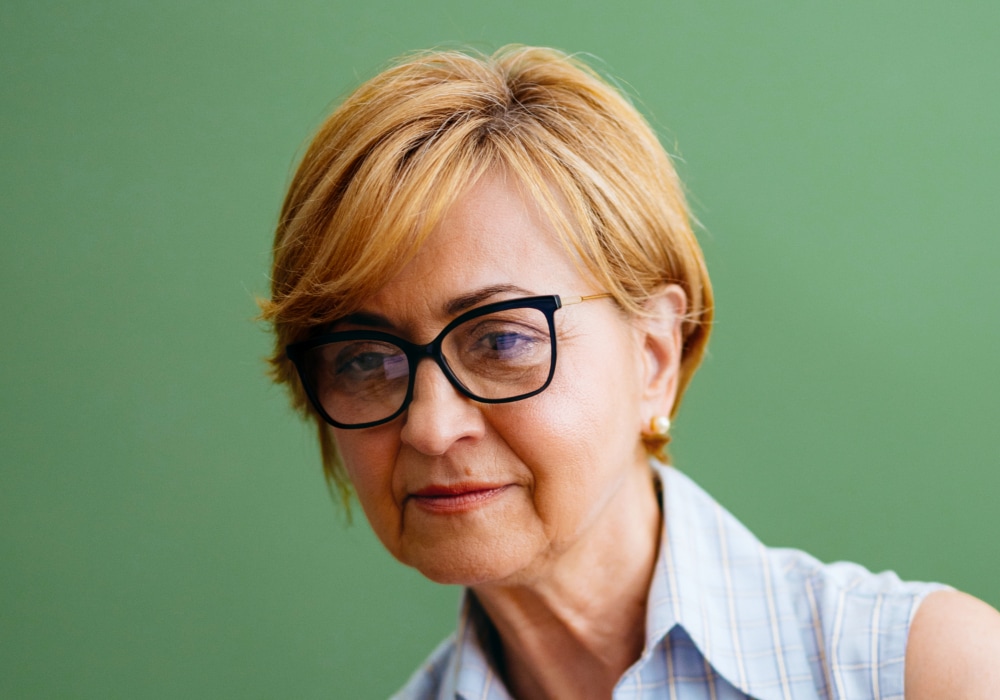 Blonde pixie cut for older women with glasses