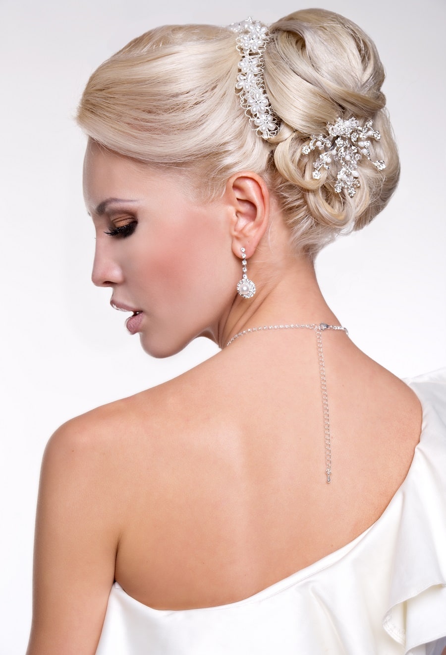 blonde updo with one shoulder wedding dress