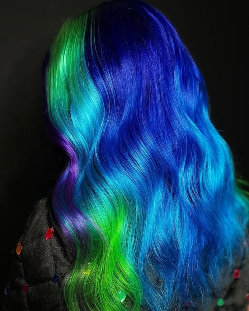 Electric blue wavy hair with violet and neon green accent panels