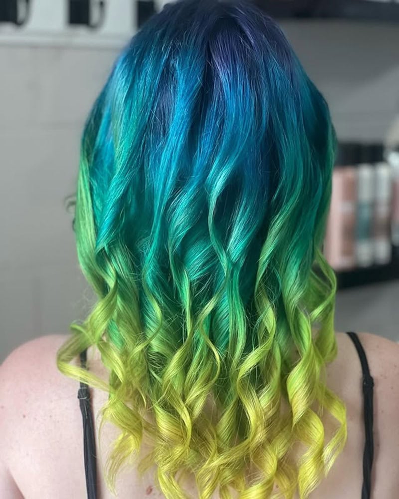 Blue and teal wavy hair melting into lime green curled ends