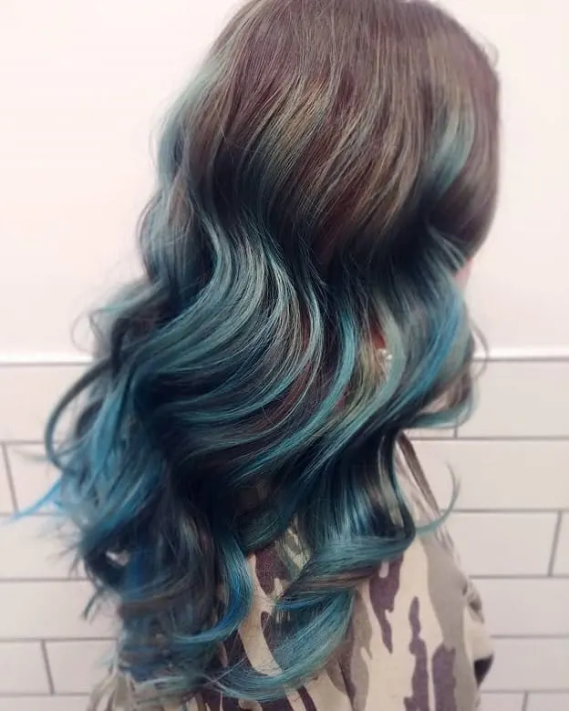 Pastel blue highlights on long brown hair