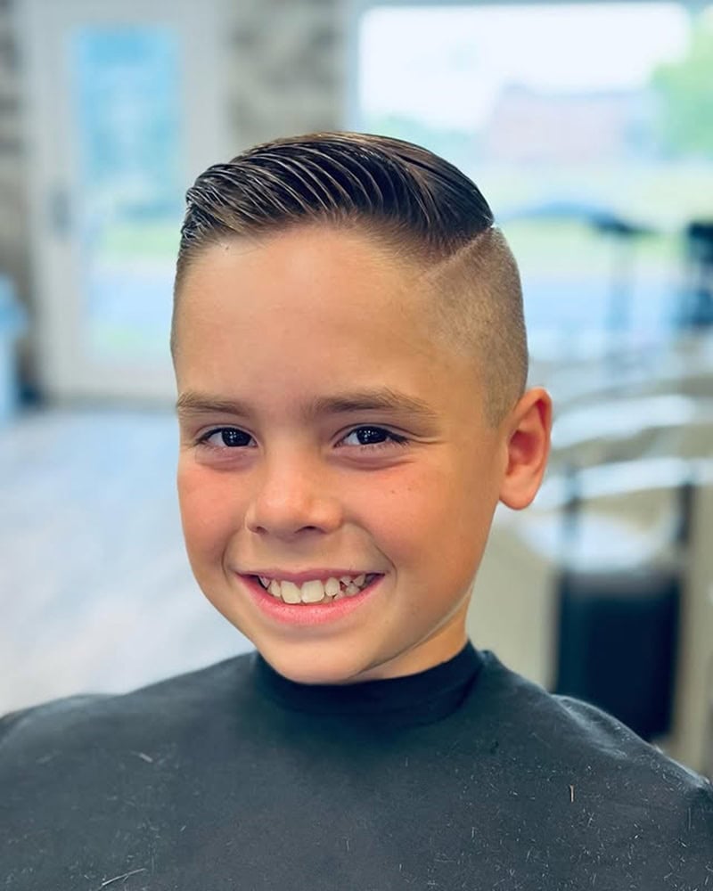 teen boy with classic hard part comb over and high skin fade
