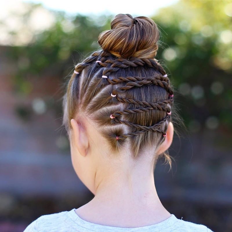9 year old girl with a braided criss-cross bun updo.