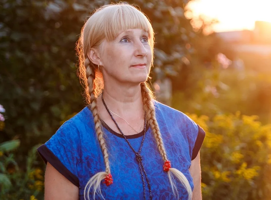 braided pigtails with blunt bangs for women over 50