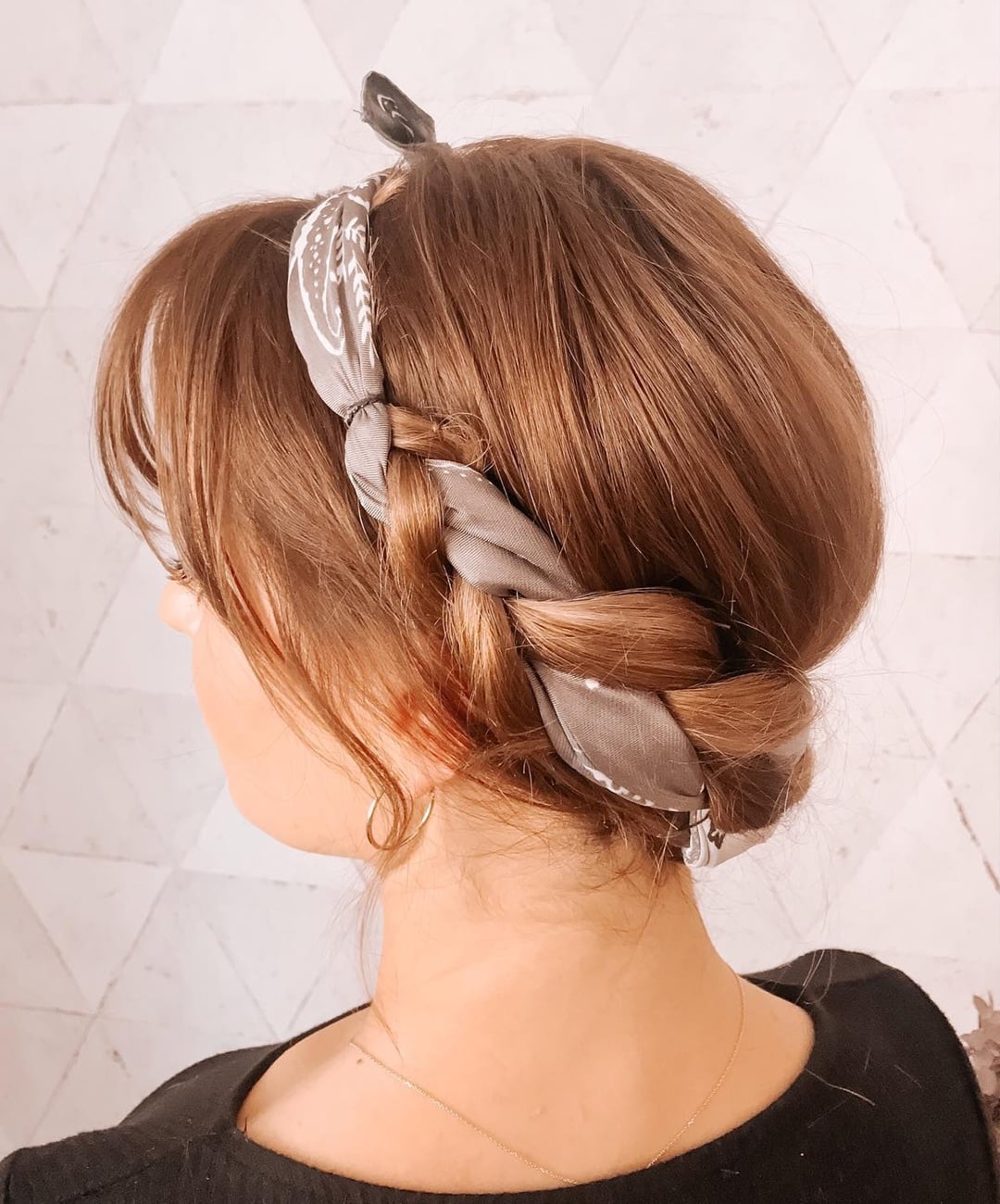 Side view of a braided scarf hairstyle wrapped neatly at the nape