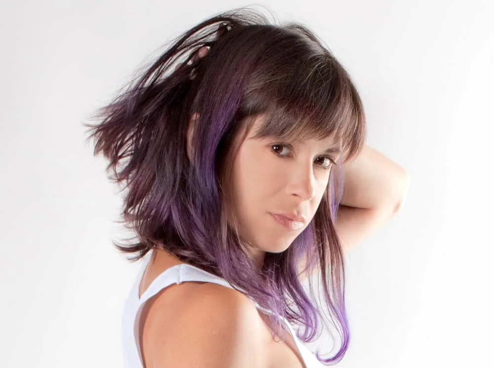 brown asymmetrical hair with purple highlights