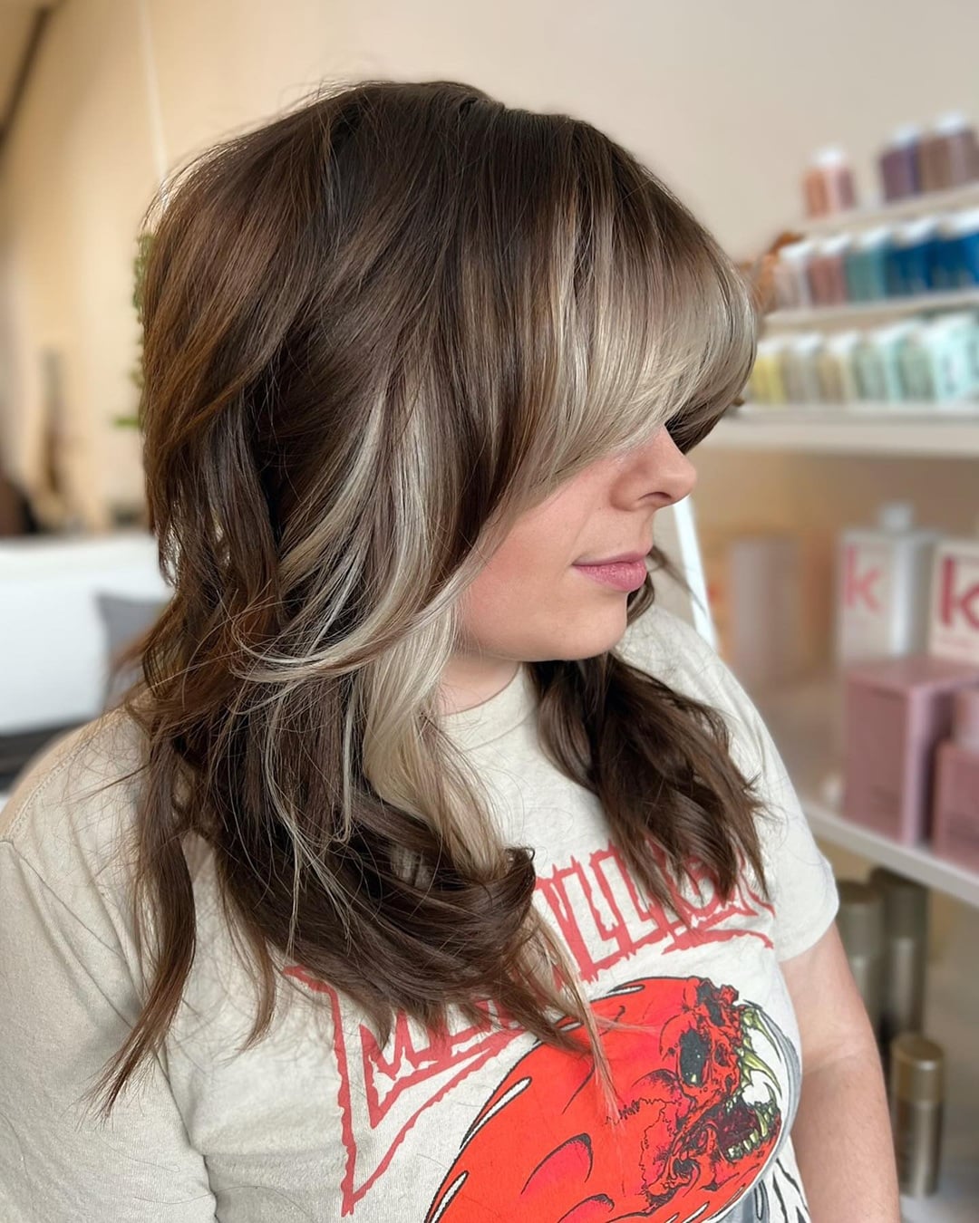 brunette wavy shag with bright blonde face-framing bangs and money piece highlights