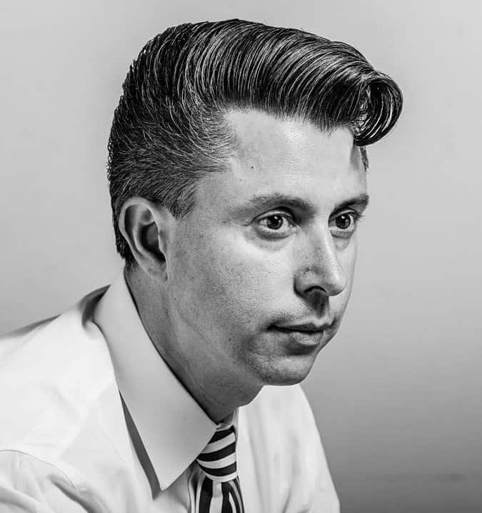 Classic brushed up comb over hairstyle styled to disguise hairline recession