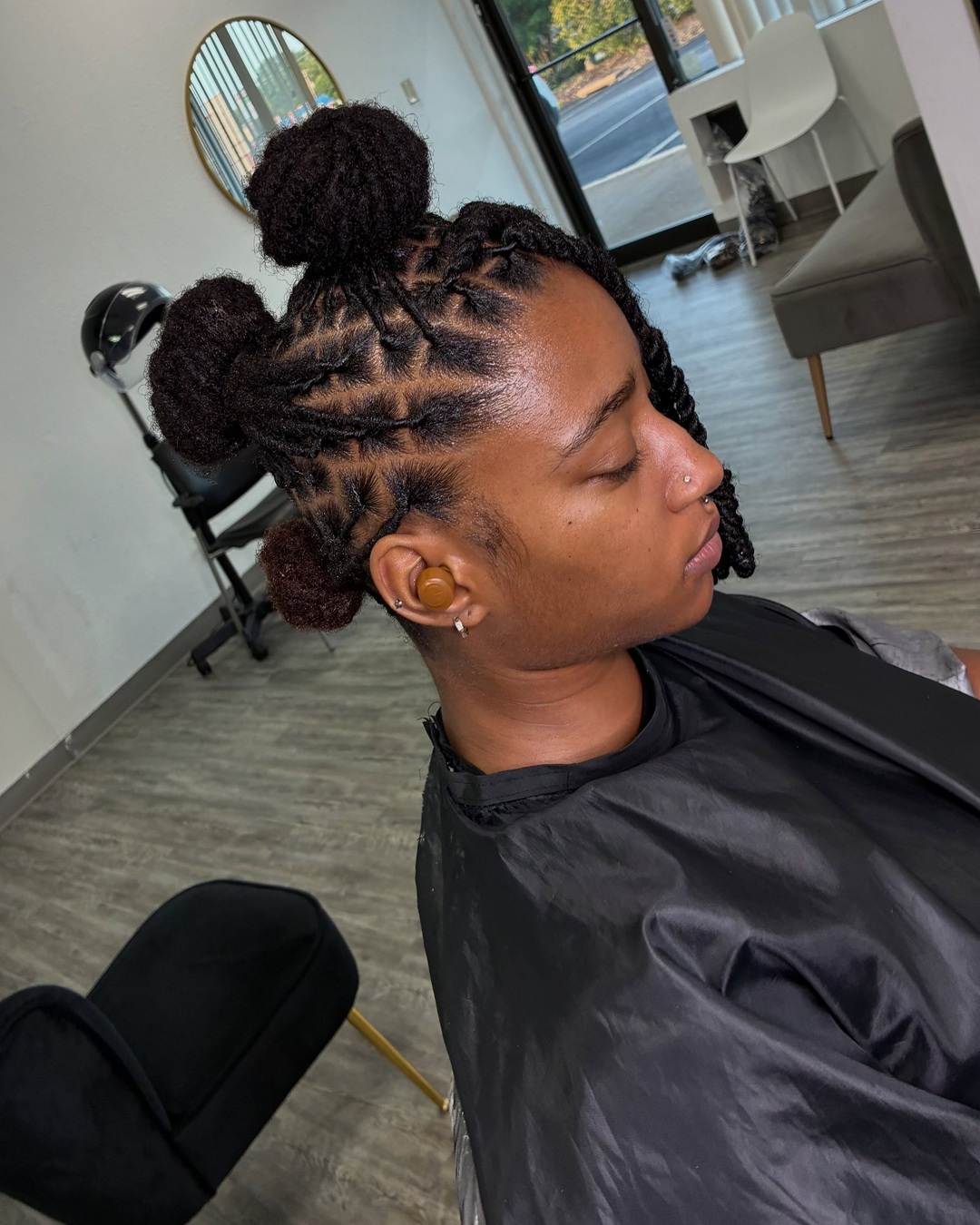 triple bun mohawk updo created with two strand twist locs