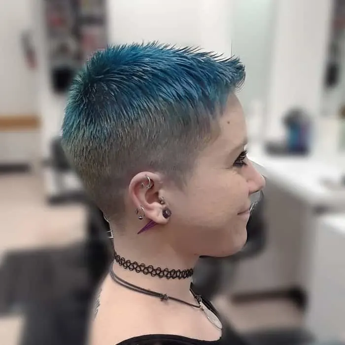 girl with blue buzz cut