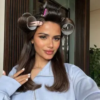 woman with hot rollers on hair