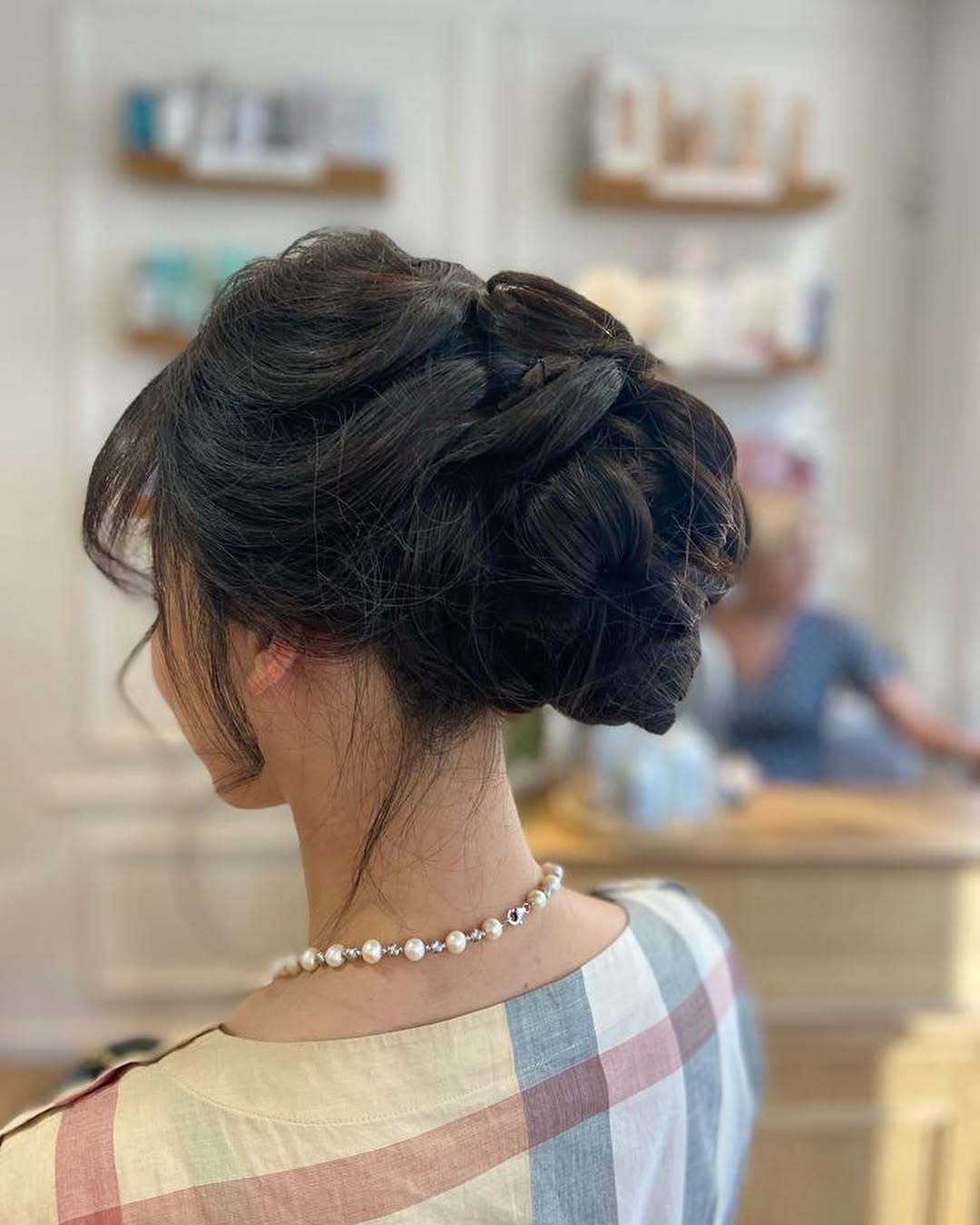 textured dark chignon bun with wispy fringe