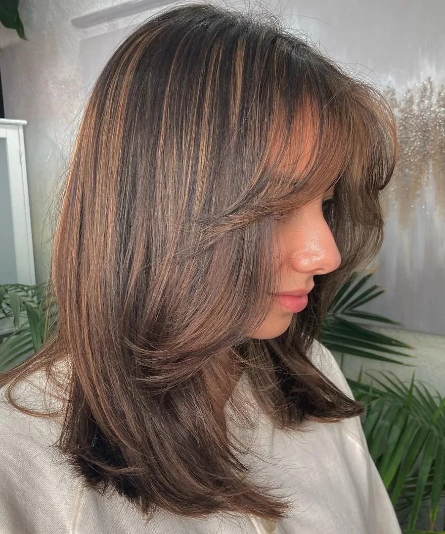 chocolate brown layered haircut with caramel highlights
