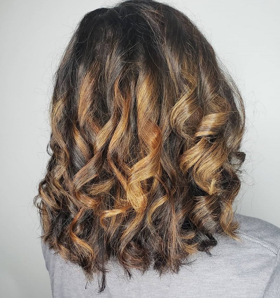 chocolate brown loose curls with caramel highlights