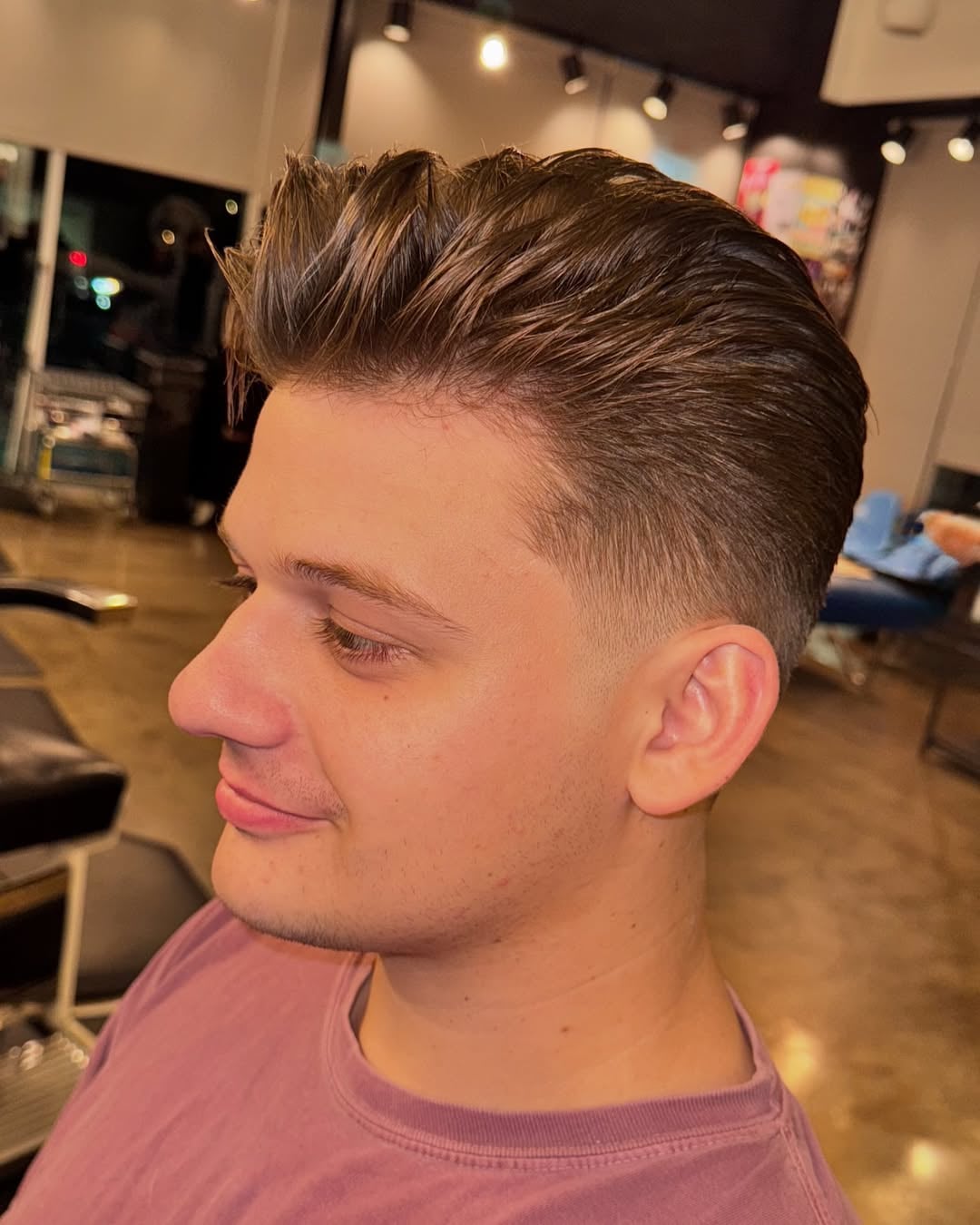 classic slicked-back 1950s greaser hairstyle with tapered sides