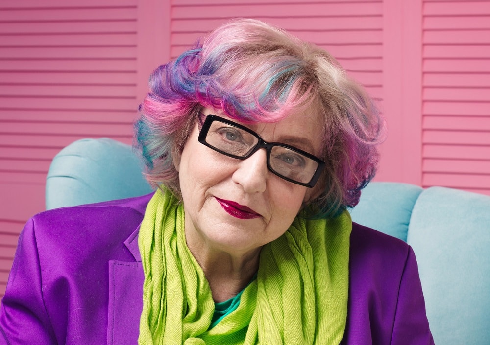 colorful bob hairstyle for over 50 with glasses