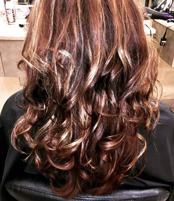 Curly copper brown hair with highlights