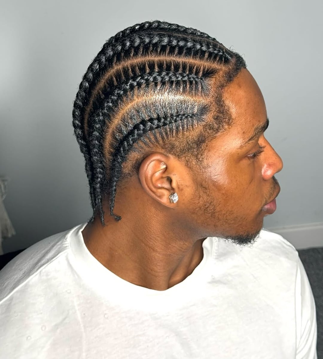 black cornrow braids for men with short hair featuring precise stitch partings