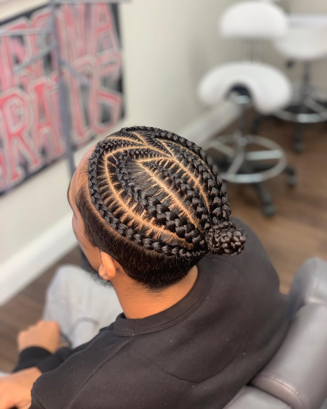 Indian man bun with braided cornrows