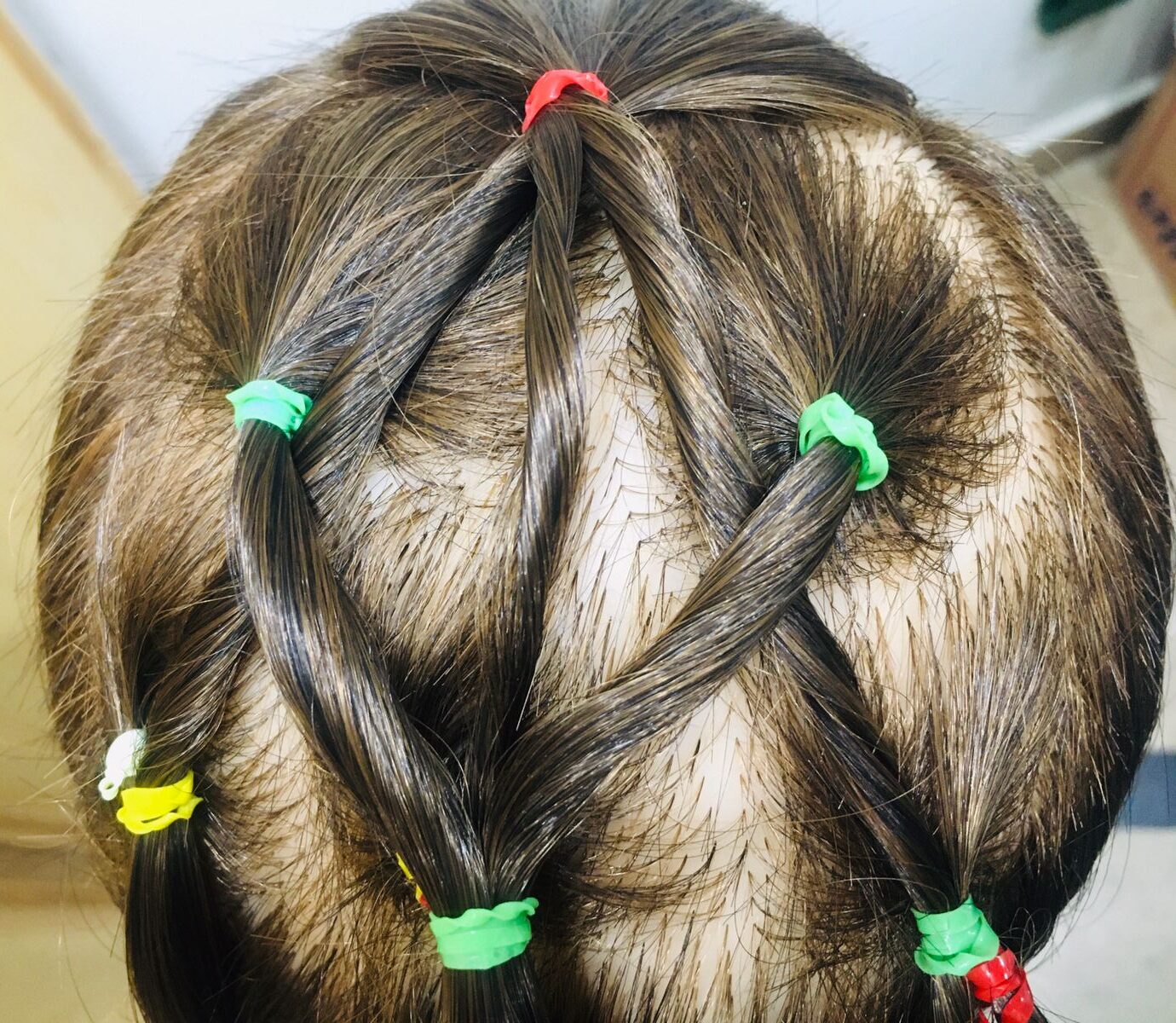 Crisscross ponytail tutorial top view on a child