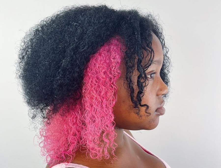 Curly black hair with pink underneath
