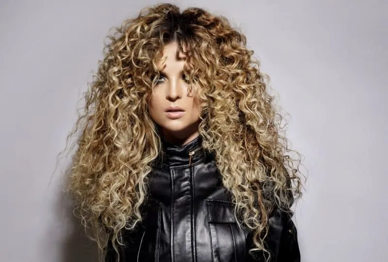 Curly blonde hair with shadow roots