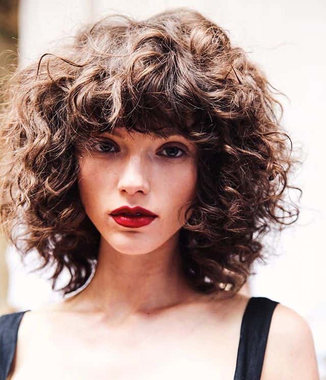 women with curly bob and bangs