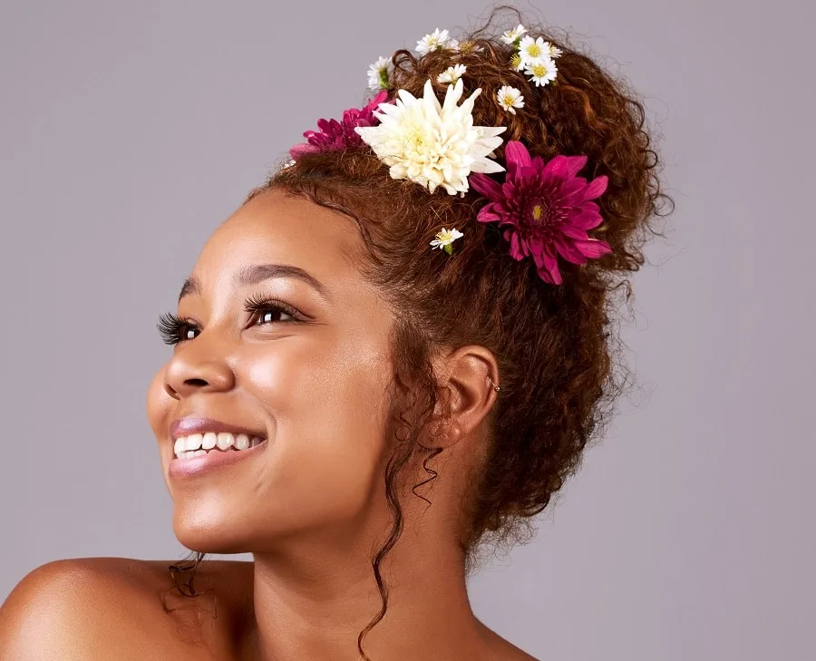 curly frizzy hair updo with flowers