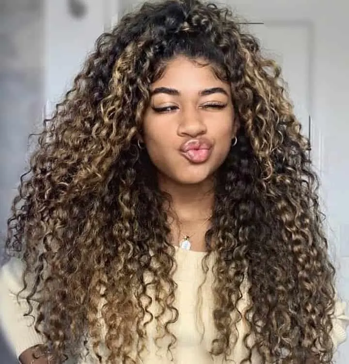 long curly hair with honey blonde highlights