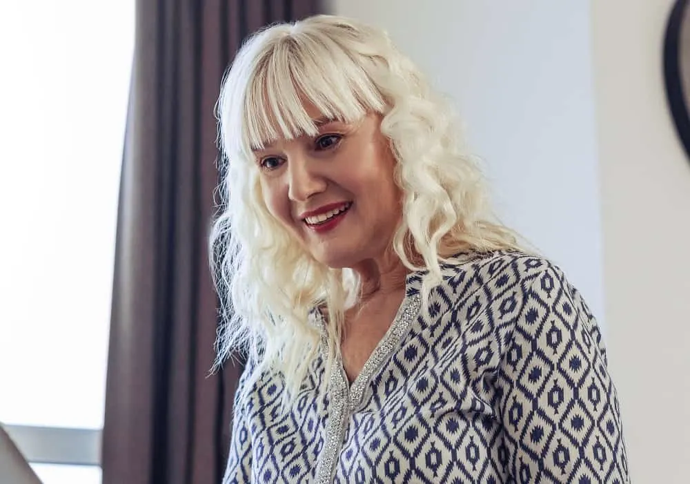 curly hair with bangs for older women